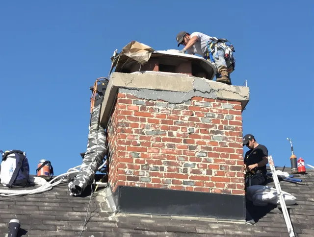 Duxbury Chimney Sweep installing a custom chimney crown in Duxbury, MA