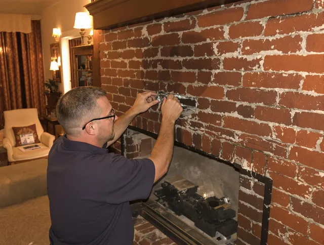 Duxbury Chimney Sweep expert fixing a fireplace in Duxbury, MA